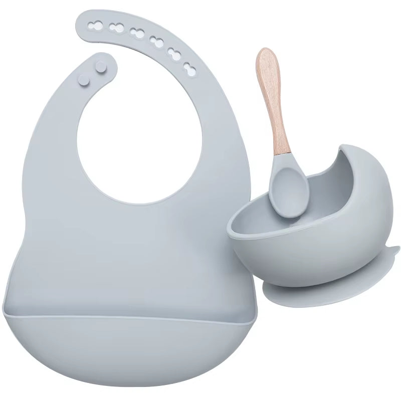 Complete feeding set with bib, bowl, and wooden spoon
