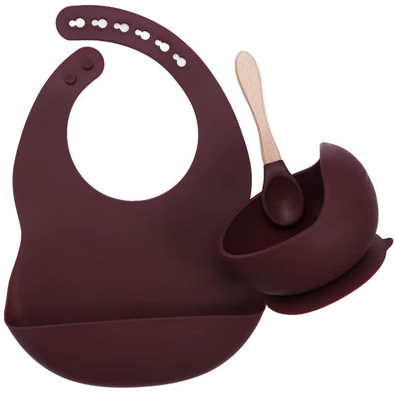 Complete feeding set with bib, bowl, and wooden spoon
