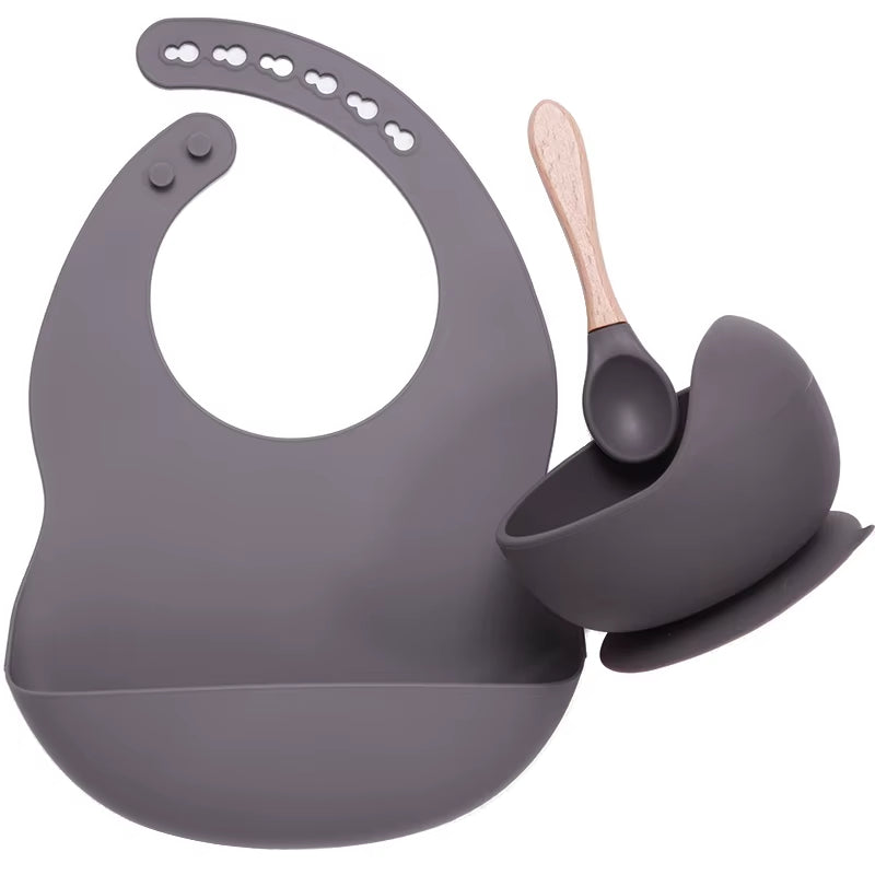 Complete feeding set with bib, bowl, and wooden spoon
