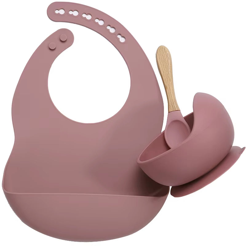 Complete feeding set with bib, bowl, and wooden spoon
