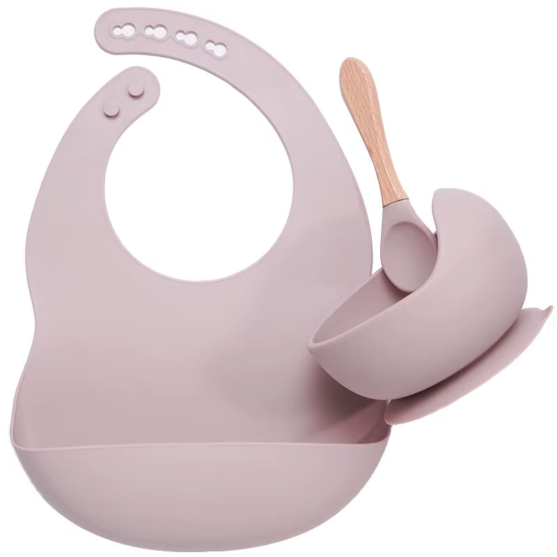 Complete feeding set with bib, bowl, and wooden spoon
