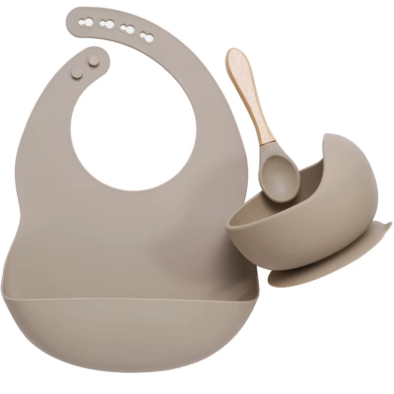 Complete feeding set with bib, bowl, and wooden spoon
