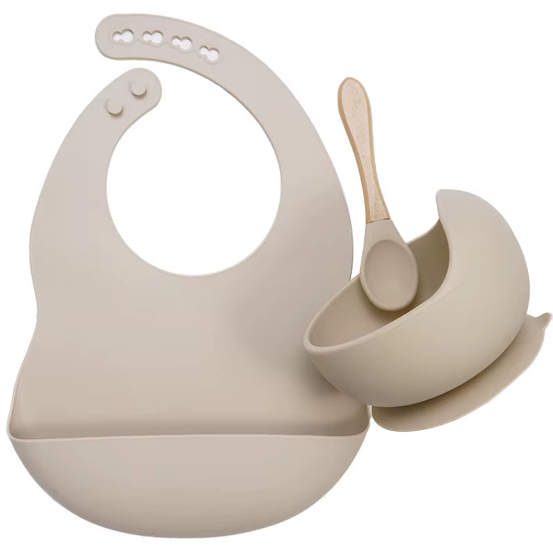 Complete feeding set with bib, bowl, and wooden spoon
