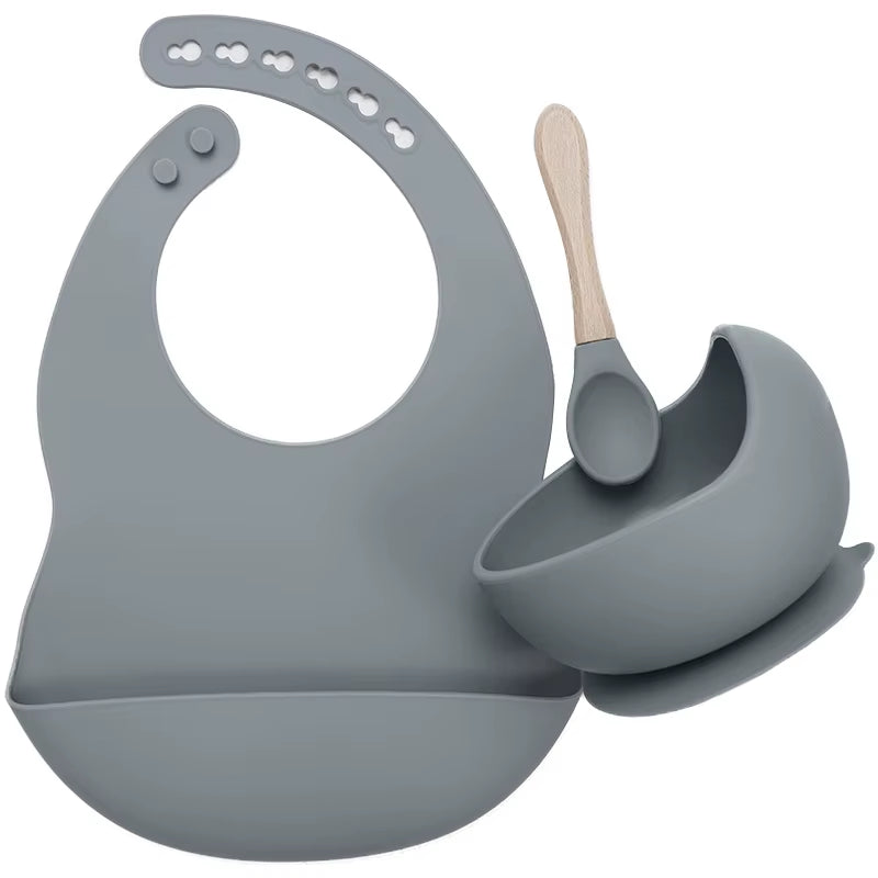 Complete feeding set with bib, bowl, and wooden spoon

